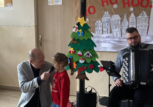 Dziewczynka śpiewa z panem Maciejem.