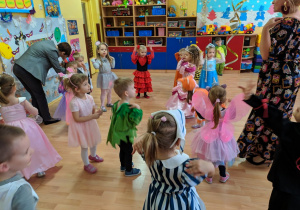 Dzieci naśladują w tańcu ruchy pokazywane przez panią.