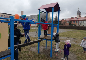 Dzieci przechodzą po lekko ruchomej belce.