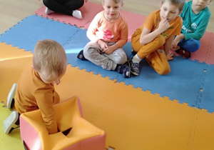 Dziecko wkłada rękę do pudełka i rozpoznaje marchewkę za pomcą dotyku