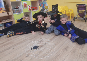 Chłopcy dumni z wykonanej sieci dla pająka