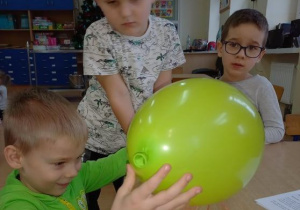 Chłopczyk sprawdza jak naelektryzowany jest balon