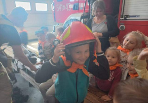 Chłopiec przymierza kask strażacki