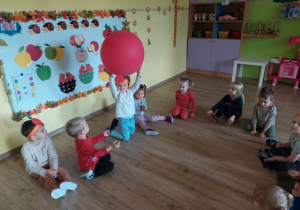 Grupa bawi się wielkim jabłkiem - balonem
